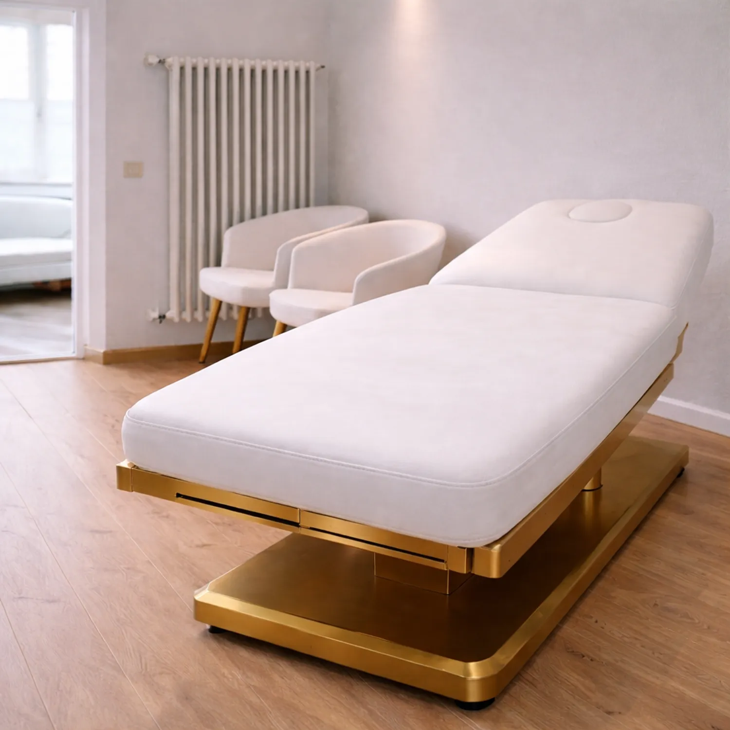 J´ARCADIA´N - International Neurosurgical Consulting - This is a luxurious Alpeda Naomi electric beauty bed featuring a white leather upholstered top and a gold-colored base.